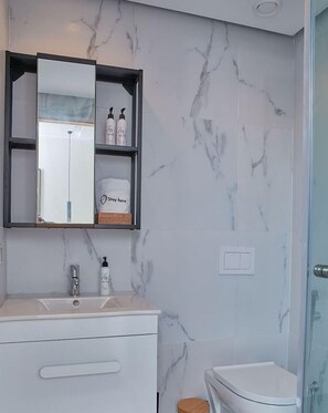 Shower, towels, soap, toilet paper