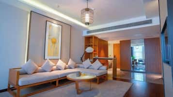 A modern living room with a sofa, coffee table, and artwork on the wall.