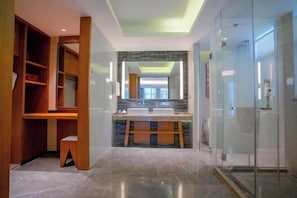 A modern bathroom with a glass shower enclosure, a vanity with a double sink, and a wooden shelving unit. - Zhongyi Hotel (Zhong County)