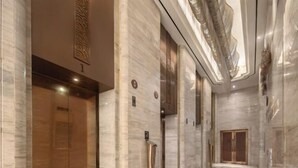 A modern interior with marble floors, wooden doors, and a decorative ceiling. - Nanting International Hotel (Changsha)