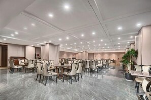 A spacious conference room with multiple tables and chairs, a marble floor, and recessed lighting. - Nanting International Hotel (Changsha)