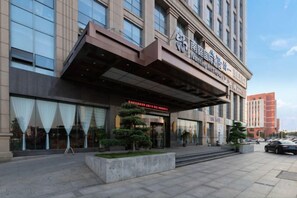 A hotel with a modern facade, large windows, and a prominent entrance. - Nanting International Hotel (Changsha)