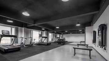 A gym with treadmills, stationary bikes, and weight machines.