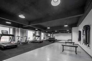 A gym with treadmills, stationary bikes, and weight machines. - Nanting International Hotel (Changsha)