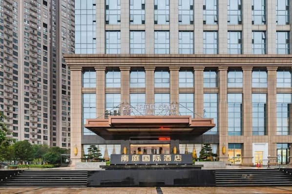 A hotel with a modern facade, large windows, and a prominent entrance.