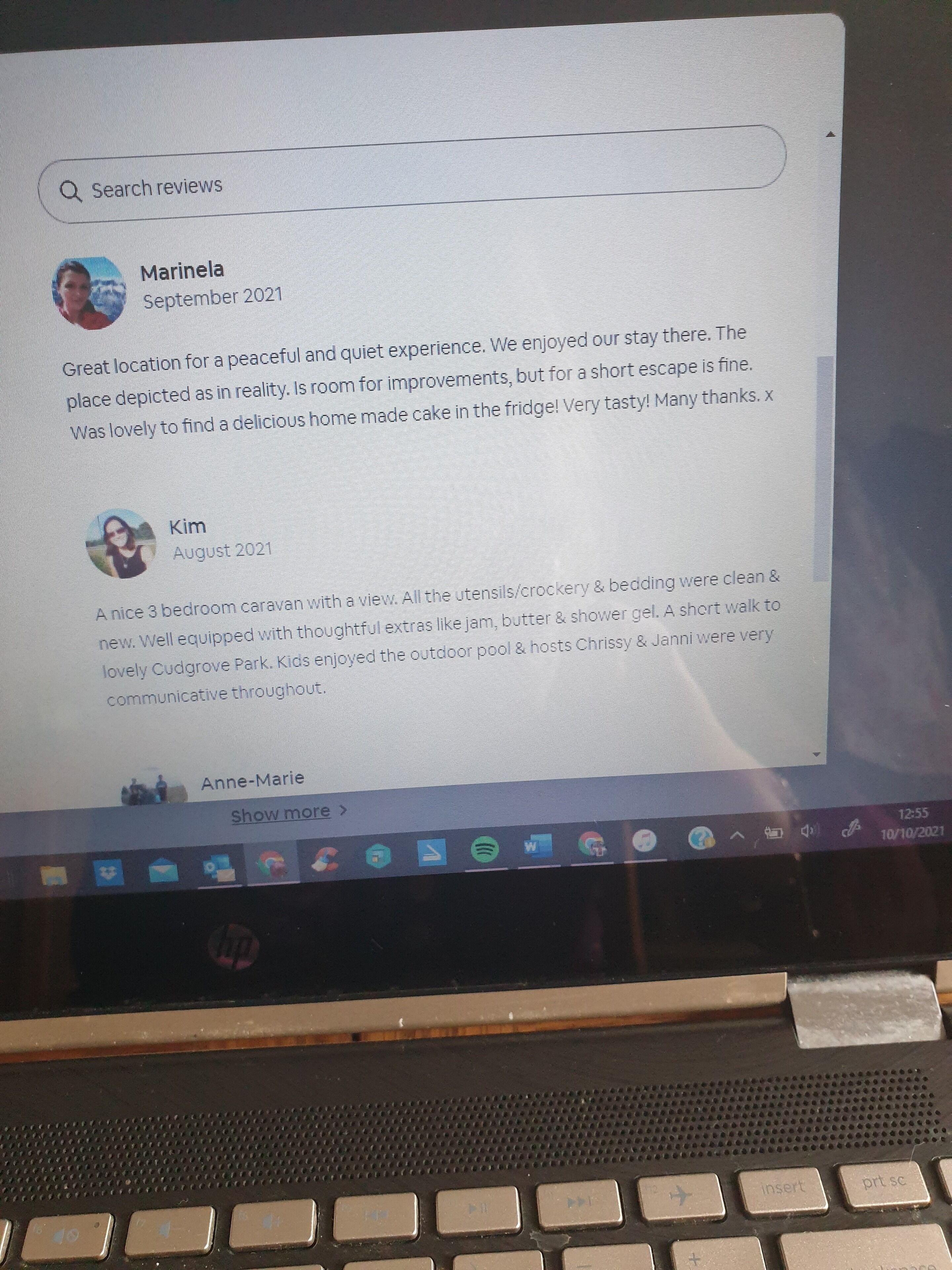 A laptop screen displaying a hotel review page with comments from guests.