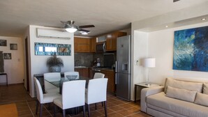 A compact living space with a dining area, kitchenette, and a sofa. - Luxury Villa at the feet of the sea In Cancun (Cancún)