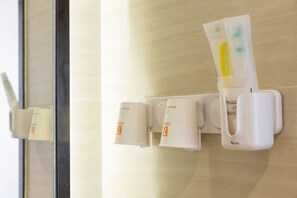 A wall-mounted dispenser with a tube of hand sanitizer and two small containers, likely for tissues. - 7 Days Premiuml (Shenzhen Longgang Universiade Center Ailian subway station) (Shenzhen)
