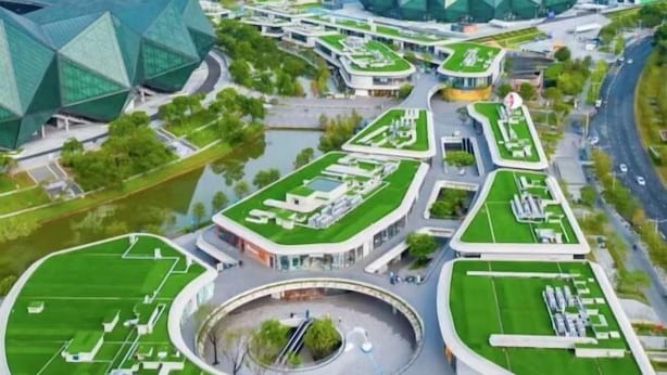 A modern architectural complex with green roofs, a central circular plaza, and multiple buildings with unique geometric designs. - 7 Days Premiuml (Shenzhen Longgang Universiade Center Ailian subway station) (Shenzhen)