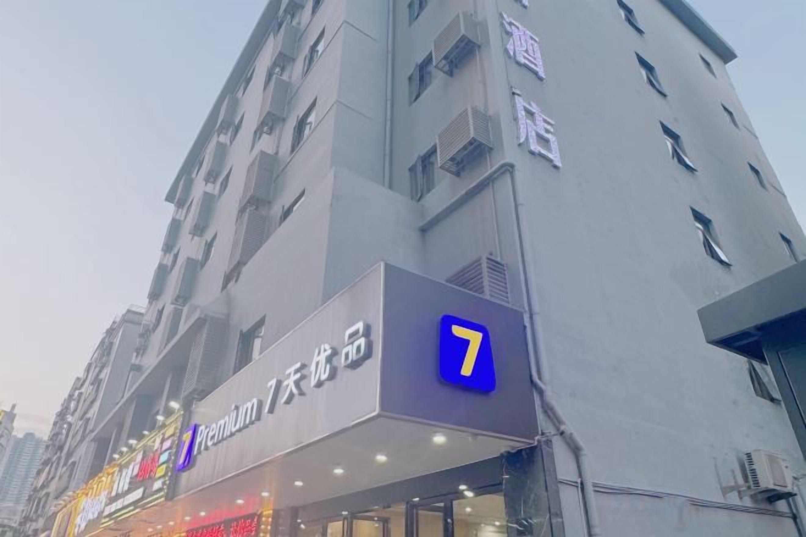 A multi-story building with a prominent '7' sign, indicating a hotel or apartment complex.