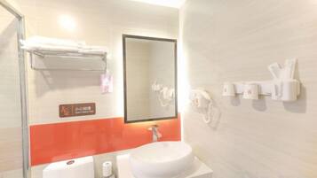 A bathroom with a sink, mirror, towel rack, and hand sanitizer dispensers.