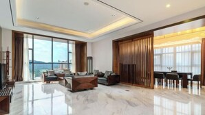 A spacious living room with a large window, a dining area, and a modern ceiling design. - Shehong Kuangyi Hotel (Yongyi Square) (Shehong)
