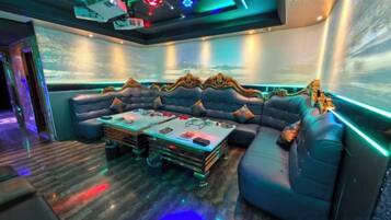 A modern lounge area with a sofa, coffee table, and ambient lighting.