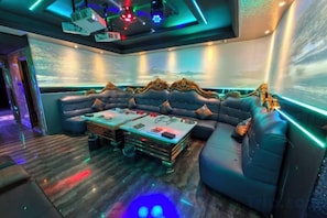 A modern lounge area with a sofa, coffee table, and ambient lighting.
