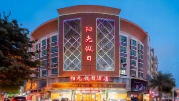 Hotel entrance with a distinctive curved facade and prominent entrance.