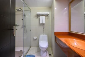 A bathroom with a glass shower enclosure, a white toilet, and an orange sink. - Sunny Holiday Hotel (Shishi)