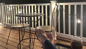 A wooden deck with a white railing, a round table, two chairs, and a glass of red wine. - Peaceful and Secluded! Lake Harmony Beautiful Townhome Ski Slope and Lake Views (Lake Harmony)