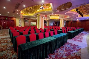 A banquet hall with rows of tables and chairs, a patterned carpet, and a decorative ceiling. - Golden Lusheng International Hotel (Rongshui)
