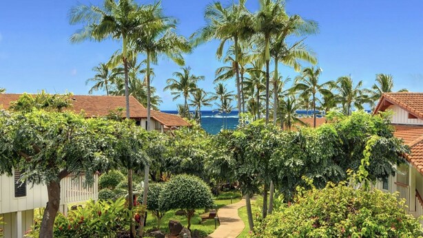 A resort with multiple buildings, palm trees, and a clear view of the ocean. - KAUAI BEST DEAL!!!!   1-10-25 thru 1-17-25    - Sleeps 8 (Koloa)