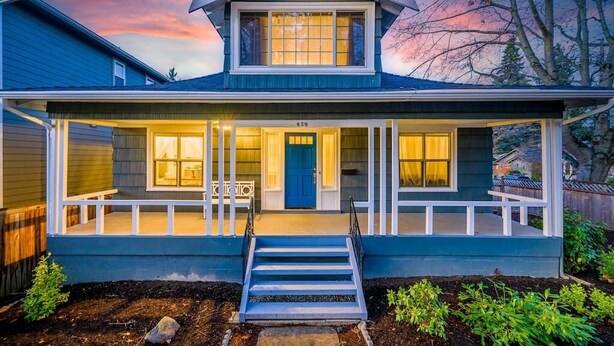 A two-story house with a front porch, a blue door, and a number "620" on the front. - Upgraded Home with 5BR/4Bath/4 FREE gated parking/EV Charger (Seattle)