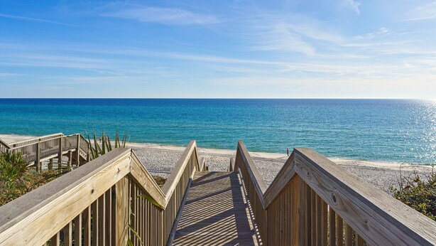 A wooden boardwalk leading to a beach with clear blue water and a bright sky. - Capistrano E101. Gulf Front, Direct private beach access, Pet Friendly. (Seacrest)