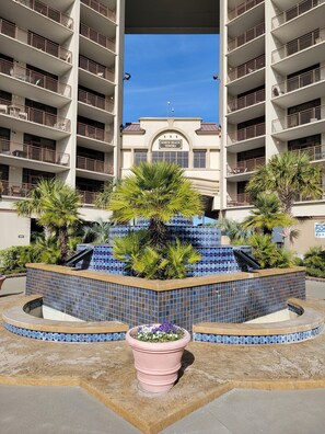 A building with multiple balconies and a sign reading "North Beach Towers".