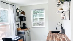 A compact kitchen with a wooden countertop, a sink, and a built-in microwave. - Washburne Studio: King size comfort and private Hot tub (Springfield)