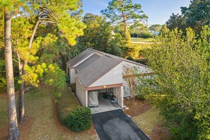 A single-story building with a covered garage and a small porch area. - 542 Augusta Dr.-Renovated, Resort Pools, On Golf Course, 6 Seat Golf Cart, (Miramar Beach)