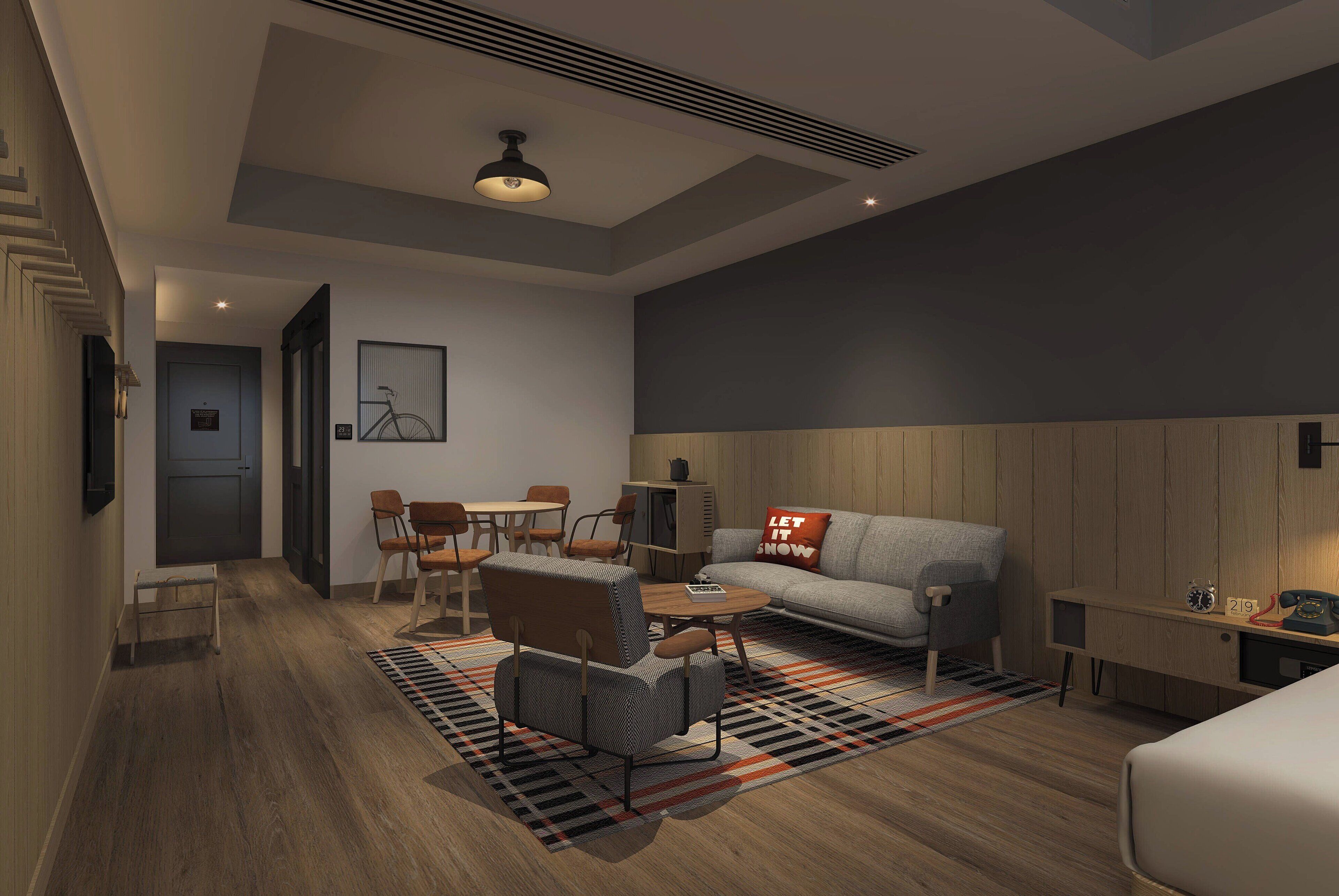 A modern living room with a sofa, armchairs, a coffee table, and a rug. There is a dining area with chairs and a table, and a small desk with a lamp.