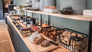 A buffet setup with various food items and kitchenware. - Hotel Valkenburg by Mercure (Valkenburg aan de Geul)