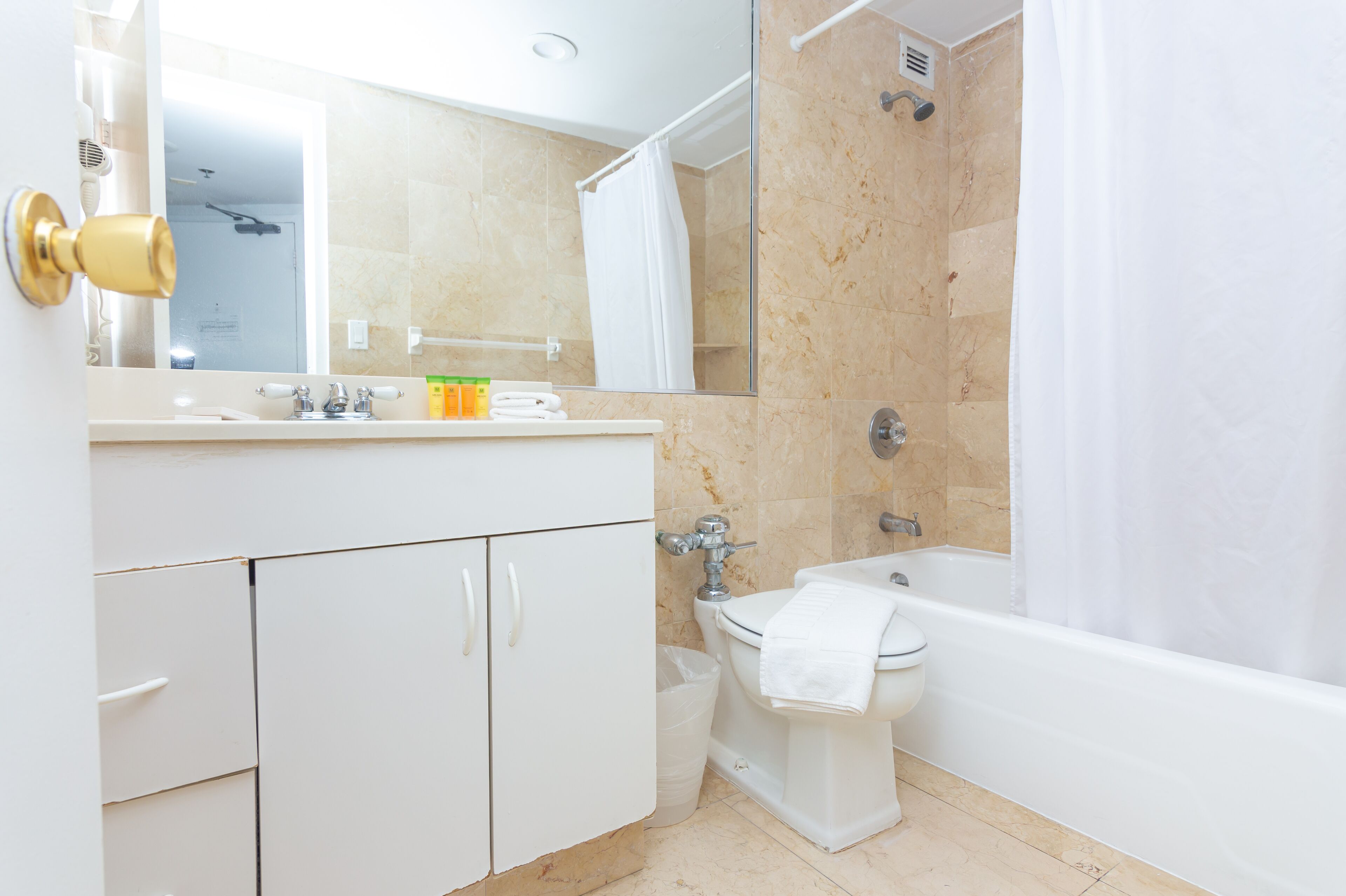 A modern bathroom with a toilet, sink, and bathtub.