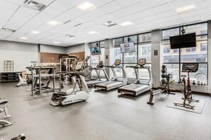 A gym with treadmills, ellipticals, and weight machines.