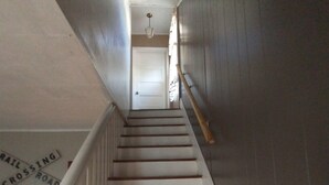 A staircase with wooden steps and white railings, leading to a door at the top. - DUPLEX....and yes you get the whole house!!! (Northfork)