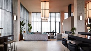 A modern hotel lobby with a large seating area, a bar, and large windows. - Hyatt Place Melbourne, Caribbean Park (Scoresby)