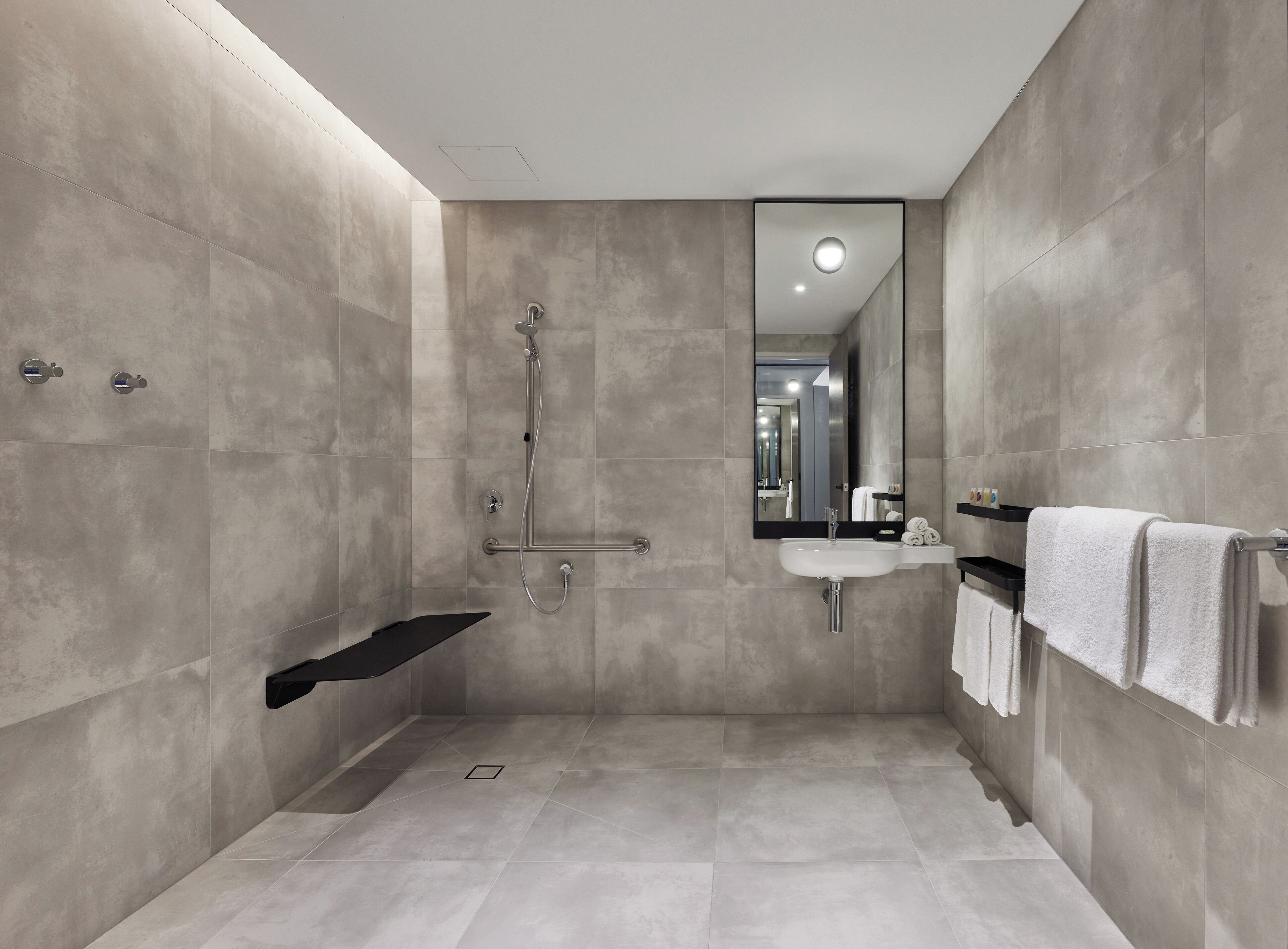 room, 1 king bed, mobility accessible | bathroom | shower, rainfall showerhead, designer toiletries, hair dryer