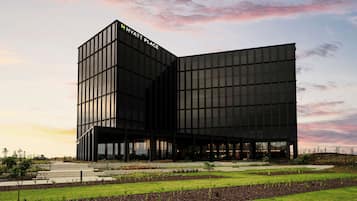 A modern Hyatt Place hotel with a distinctive black facade and large windows.