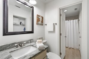 A bathroom with a sink, mirror, towel rack, and shower curtain. - Windancer 201. Gulf Front, Free Beach Service, Pool, Grill, Beautiful Views! (Miramar Beach)