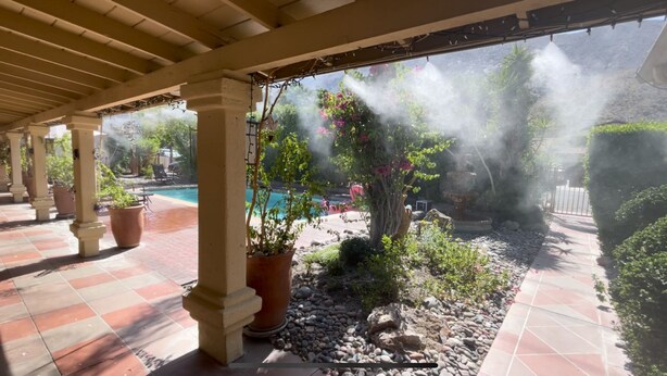 A covered patio with a pool, potted plants, and a fountain. - Villa E - a cozy studio in the heart ♥️ of downtown Palm Springs! (Palm Springs)