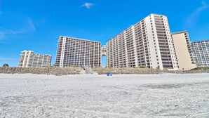 A beachfront hotel with multiple high-rise buildings, a sandy beach, and a clear blue sky. - Labor Day Is Available Breathe Taking North Beach Resort Ocean Front Condo (North Myrtle Beach)