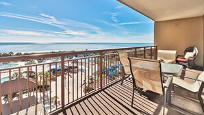 A balcony with a view of a beach and a pool area. - Labor Day Is Available Breathe Taking North Beach Resort Ocean Front Condo (North Myrtle Beach)