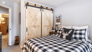 A bedroom with a checkered bedspread, a wooden wardrobe, and a teddy bear decoration. - Walk to Village - Bike Path Access - Pet Friendly 2 BR - Gear Storage - Sleeps 6 (Mammoth Lakes)