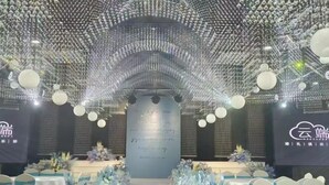 An indoor event space with a stage, rows of tables, and chairs. - Jinhao International Hotel (Huaining)