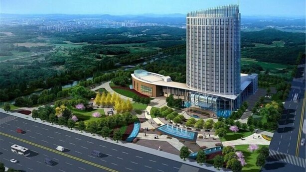 A modern hotel with a tall central tower, a curved building, and landscaped gardens. - Jinhao International Hotel (Huaining)