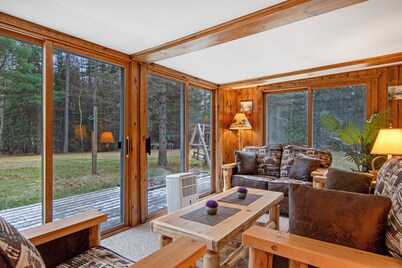 Lakefront Home with a Private Dock, Deck, Fireplace, Spacious Yard, & Playset