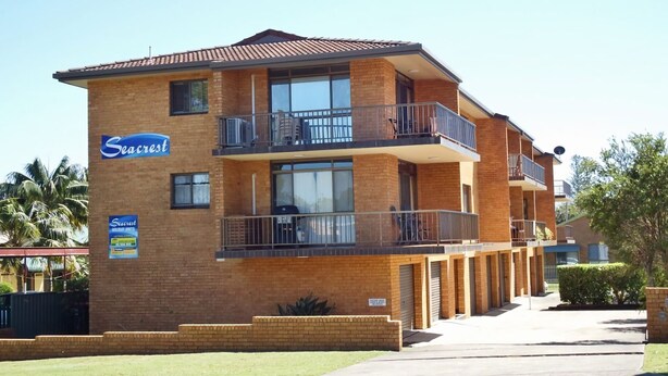 A two-story motel with a brick facade, balconies on each floor, and a clear sky. - Seacrest # 5  - South West Rocks (SOUTH WEST ROCKS)