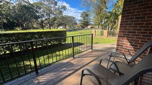 A balcony with a view of a well-maintained lawn and a brick building. - Parkside # 1 - South West Rocks - Bring your own linen (South West Rocks)
