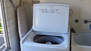 Eine weiße Toilette mit einem Schild, auf dem steht: LEAVE LID UP AFTER USE.