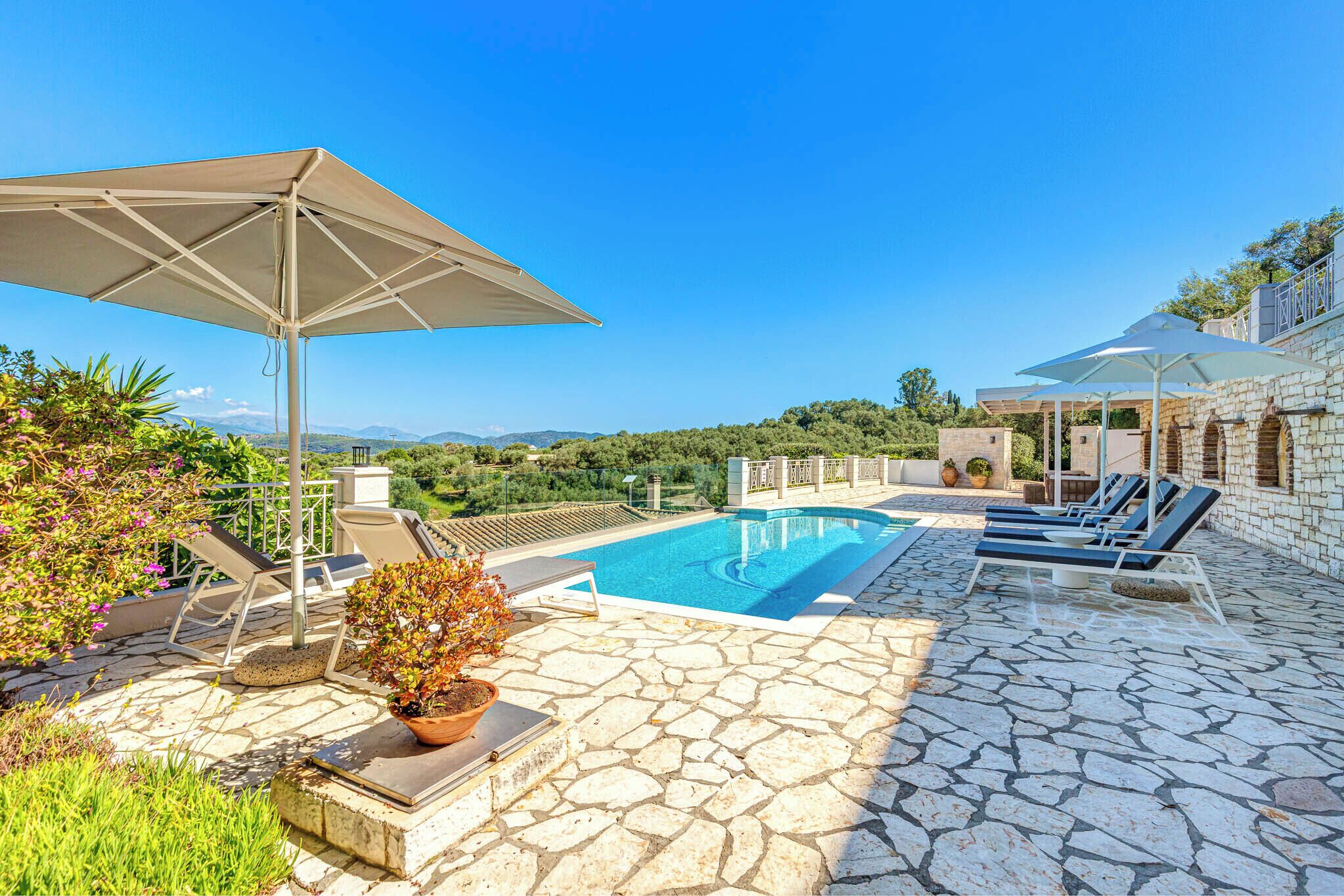 Outdoor pool, a heated pool, pool umbrellas, pool loungers