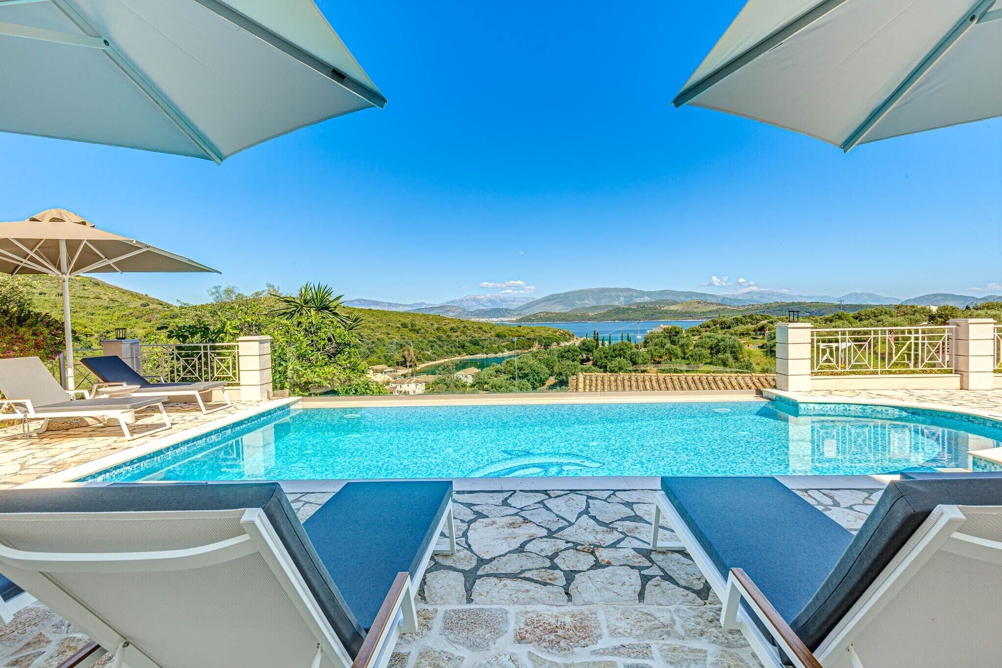 Outdoor pool, a heated pool, pool umbrellas, pool loungers
