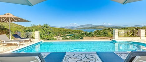 Outdoor pool, a heated pool, pool umbrellas, pool loungers